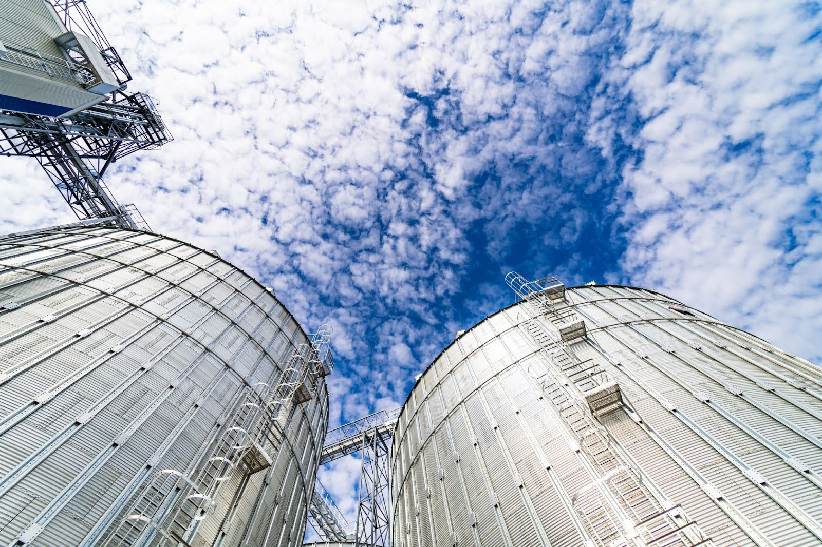 A birdseye view of flour silos from the ground